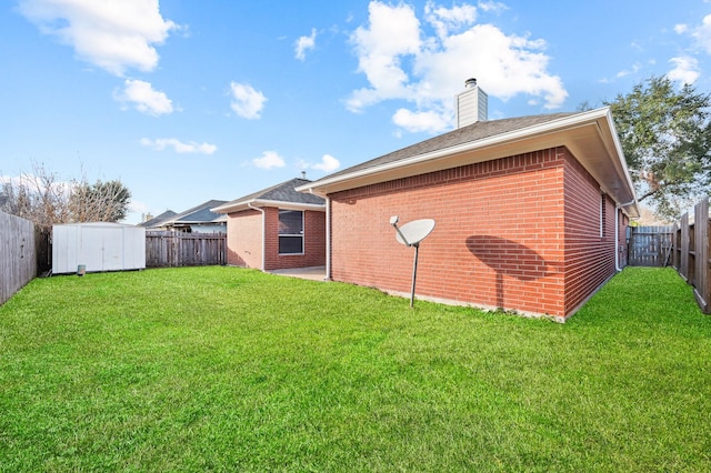 back of property featuring a shed and a yard