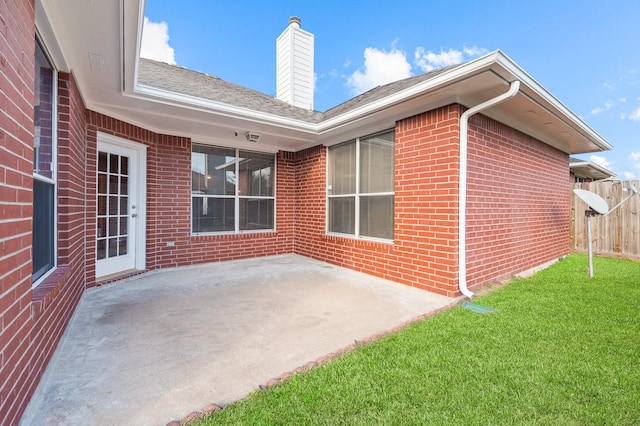 exterior space with a patio and a lawn