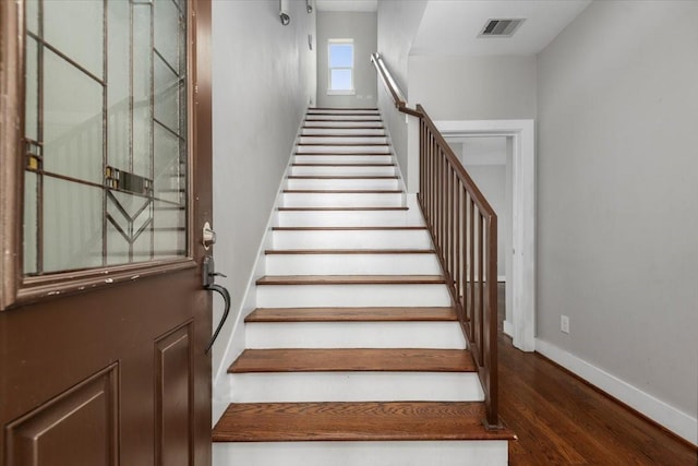 staircase featuring hardwood / wood-style floors