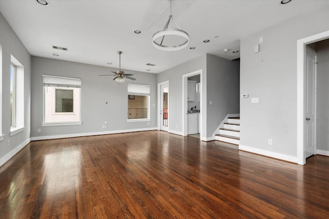 unfurnished living room featuring dark hardwood / wood-style flooring and ceiling fan