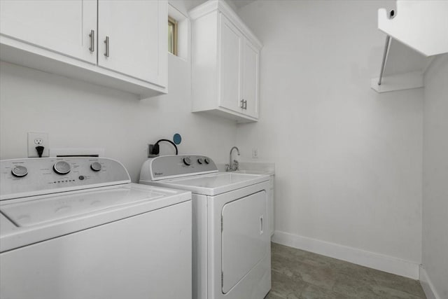 laundry area with cabinets, sink, and washer and clothes dryer