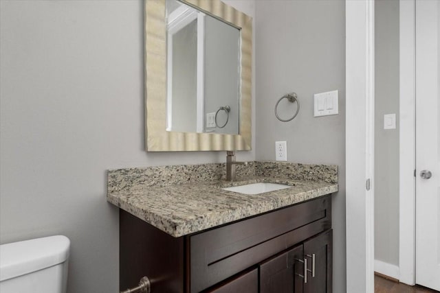 bathroom featuring vanity and toilet