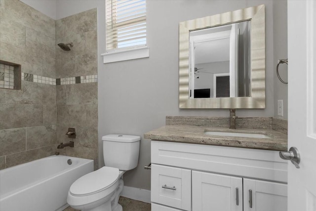 full bathroom featuring vanity, toilet, and tiled shower / bath combo