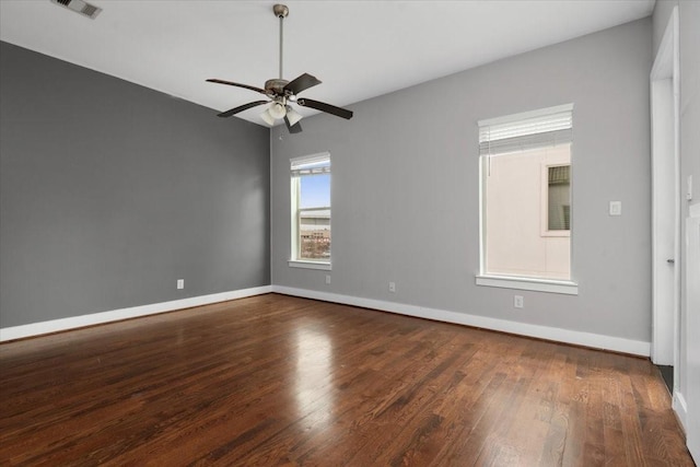 unfurnished room featuring dark wood-type flooring and ceiling fan