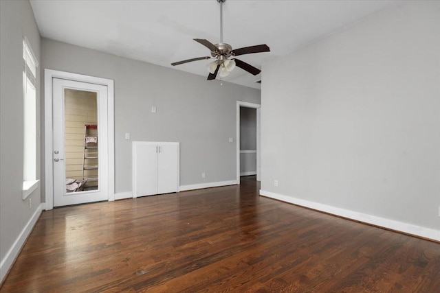 unfurnished room with ceiling fan and dark hardwood / wood-style flooring