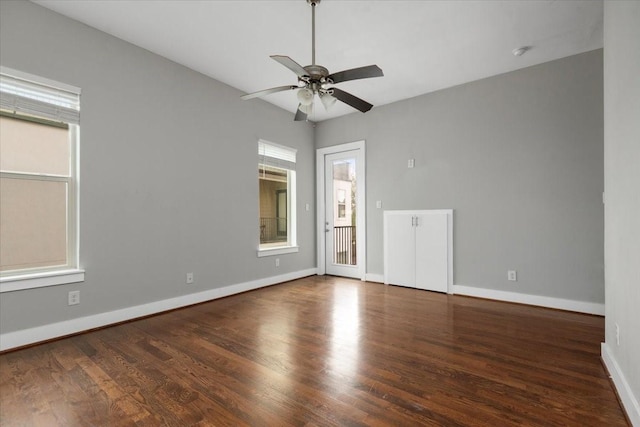 spare room featuring ceiling fan and dark hardwood / wood-style flooring