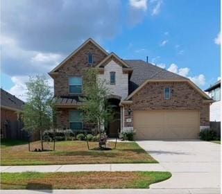 view of front of property with a garage and a front yard