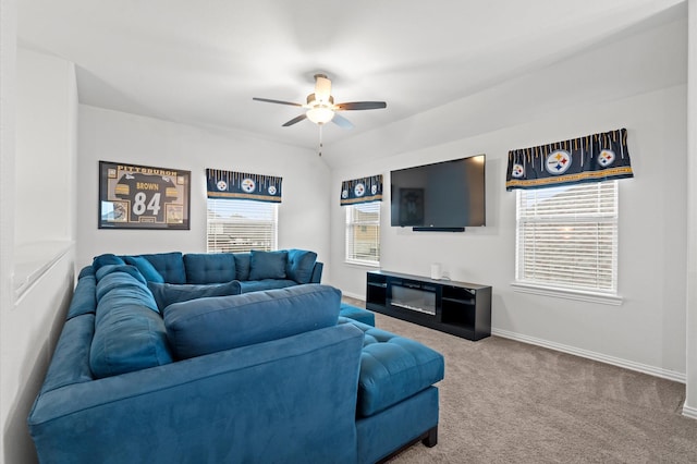 living room featuring ceiling fan, vaulted ceiling, and carpet