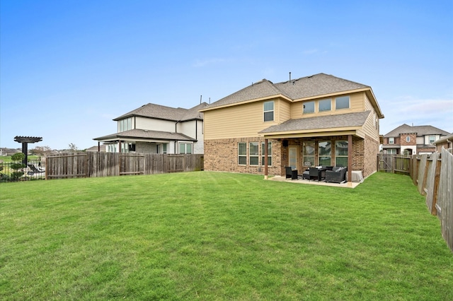 rear view of house with a lawn and a patio area