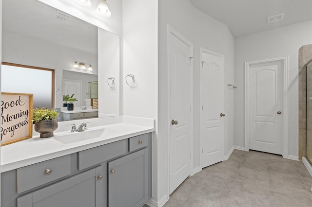 bathroom with vanity, tile patterned floors, and a shower with door