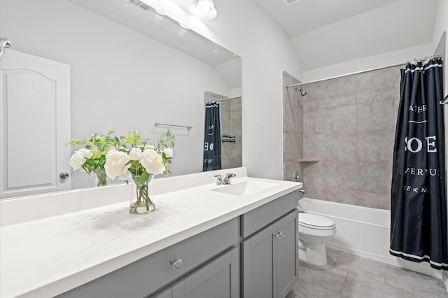 full bathroom with lofted ceiling, vanity, toilet, shower / bathtub combination with curtain, and tile patterned floors