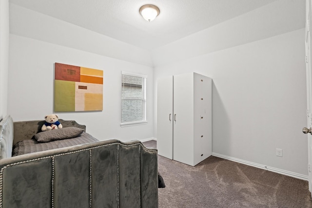 bedroom with vaulted ceiling and carpet