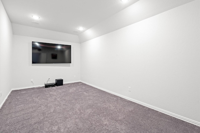 unfurnished room featuring vaulted ceiling and carpet flooring