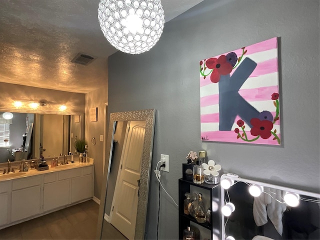 bathroom with vanity and a textured ceiling