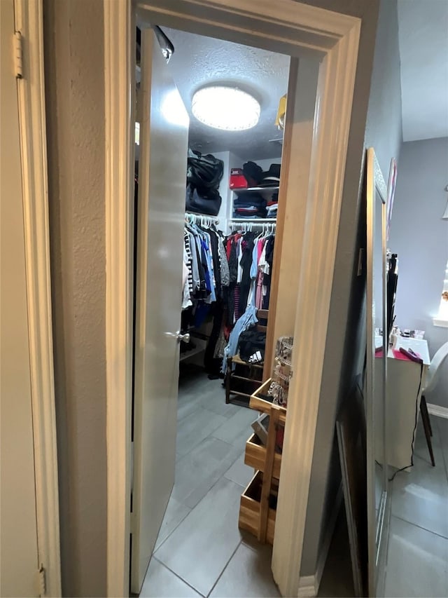 walk in closet featuring light tile patterned floors