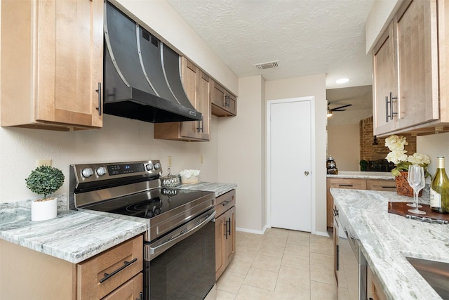 kitchen with range hood, light tile patterned floors, light stone counters, a textured ceiling, and electric stove