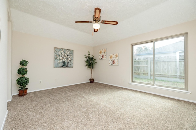 spare room featuring ceiling fan, carpet floors, and a textured ceiling