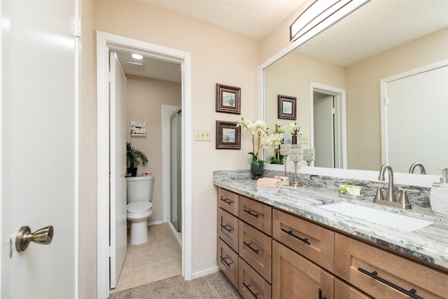 bathroom with vanity, an enclosed shower, and toilet