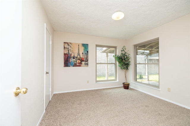 carpeted spare room featuring a textured ceiling