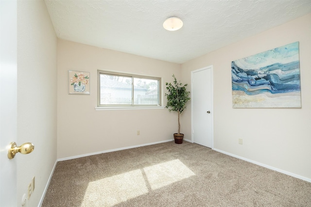 carpeted spare room featuring a textured ceiling