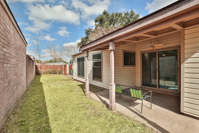 view of yard featuring ceiling fan and a patio