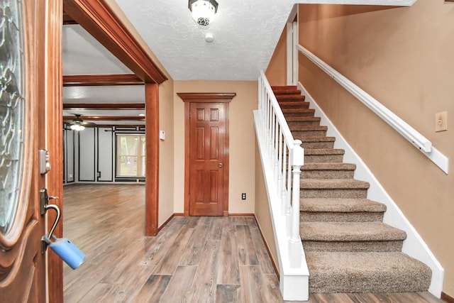 entrance foyer with wood-type flooring and a textured ceiling