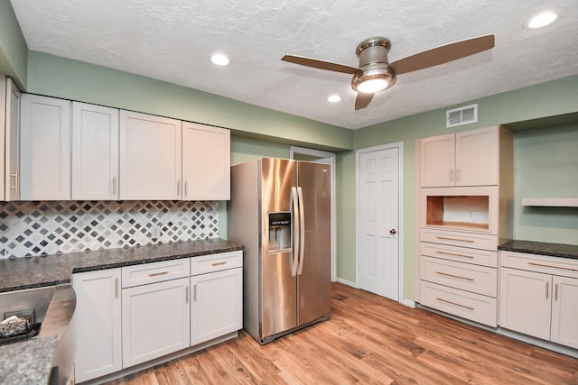 kitchen with light hardwood / wood-style flooring, ceiling fan, dark stone countertops, white cabinets, and stainless steel fridge with ice dispenser