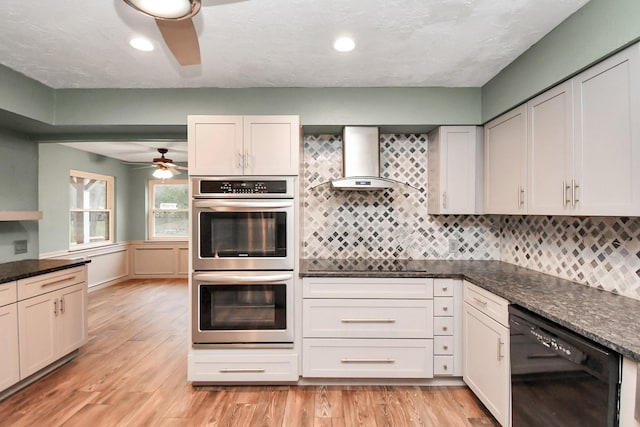 kitchen featuring white cabinetry, dishwasher, stainless steel double oven, and wall chimney exhaust hood