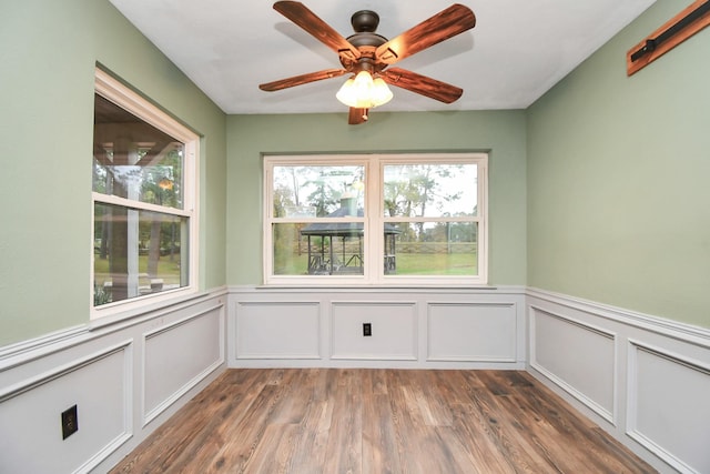 unfurnished sunroom featuring ceiling fan