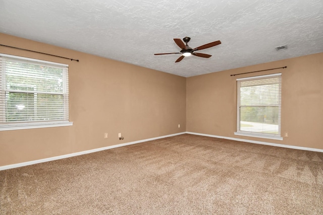 spare room featuring ceiling fan, a textured ceiling, and carpet flooring