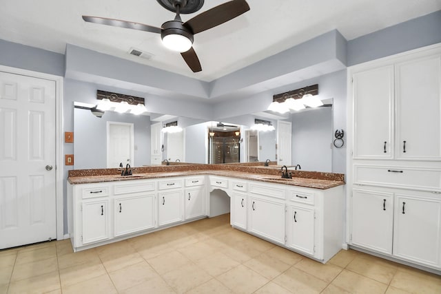 bathroom with ceiling fan, vanity, and tile patterned flooring