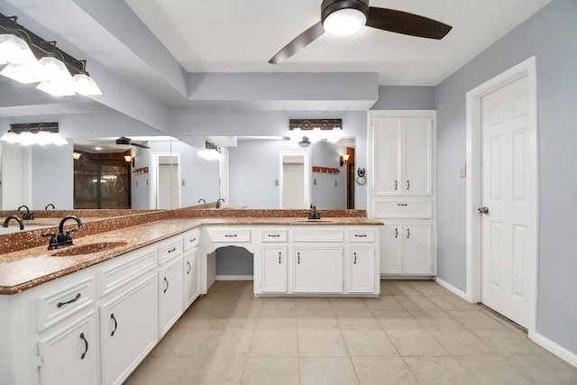 bathroom featuring ceiling fan, vanity, tile patterned floors, and a shower