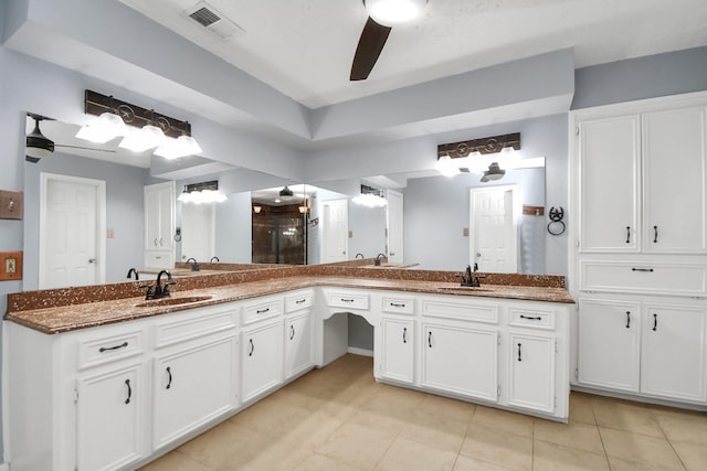 bathroom featuring a shower with door, vanity, tile patterned floors, and ceiling fan