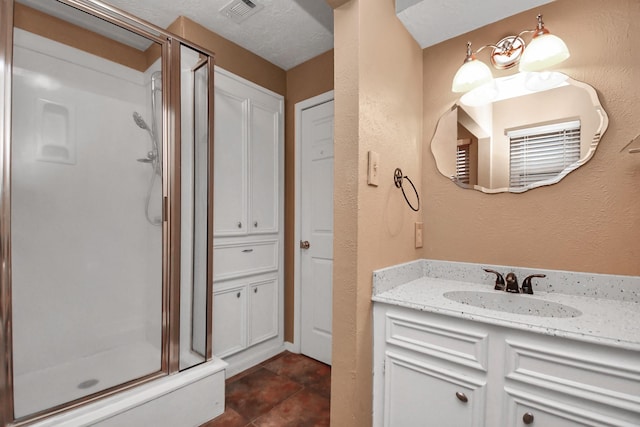 bathroom featuring vanity and an enclosed shower