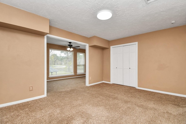 unfurnished bedroom featuring a closet, carpet, and a textured ceiling