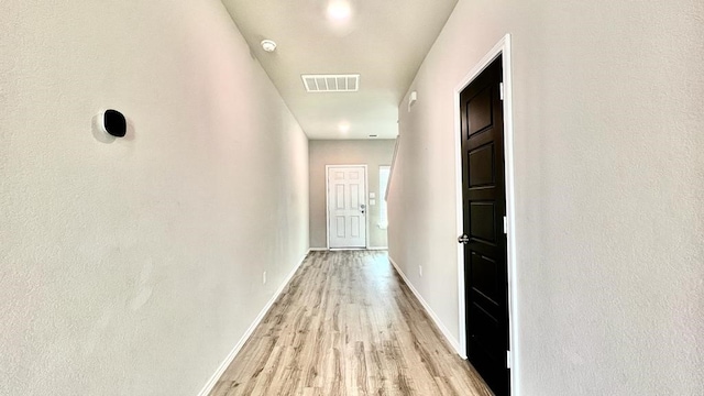 hall with light wood-type flooring