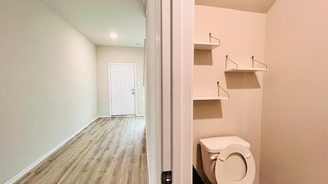 bathroom with wood-type flooring and toilet