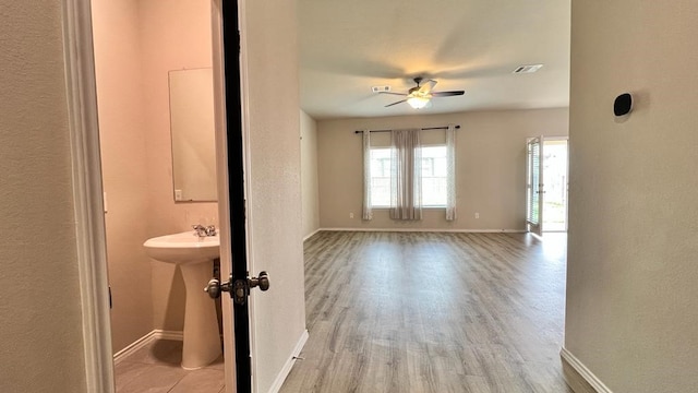 interior space with ceiling fan and light wood-type flooring