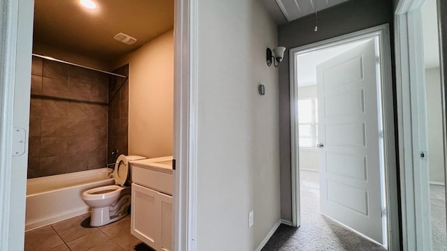 full bathroom featuring vanity, toilet, tiled shower / bath combo, and tile patterned flooring