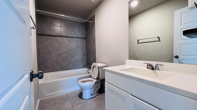 full bathroom featuring tiled shower / bath, vanity, tile patterned floors, and toilet