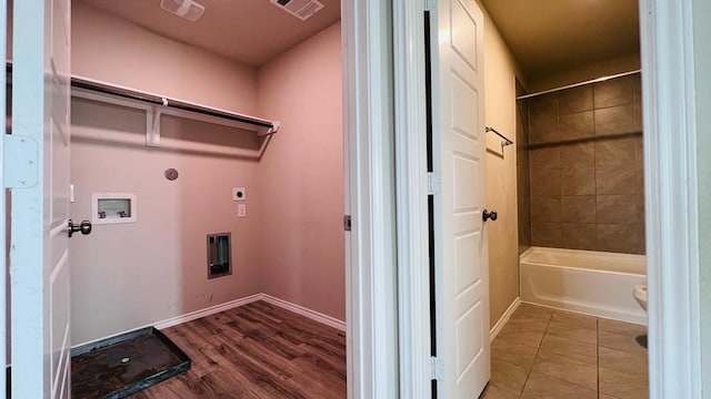 laundry area featuring electric dryer hookup, hookup for a washing machine, and tile patterned floors