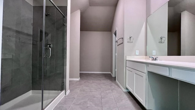 bathroom with walk in shower, vanity, tile patterned flooring, and vaulted ceiling