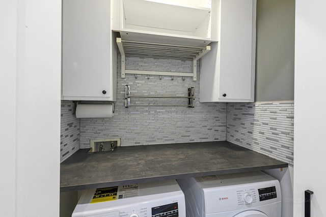 kitchen with washer / clothes dryer, backsplash, and white cabinets