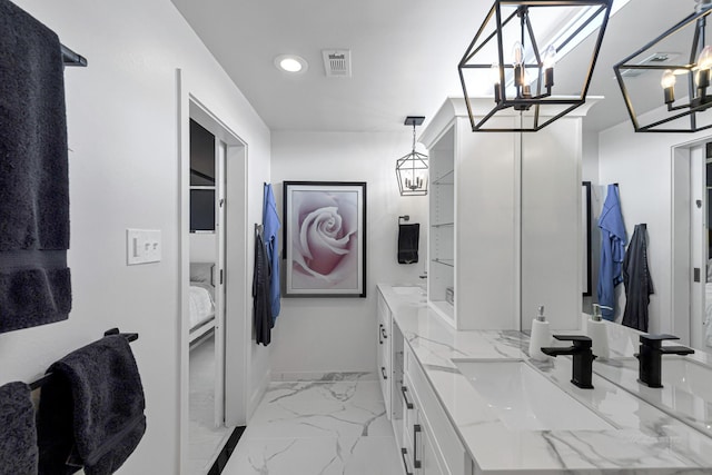 bathroom featuring vanity and a chandelier