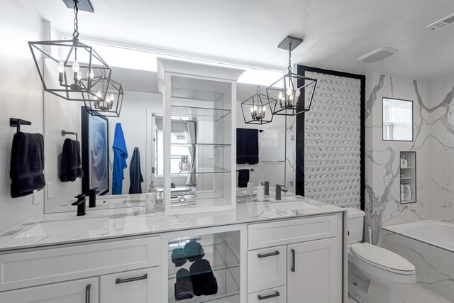 full bathroom with vanity, tiled shower / bath combo, toilet, and an inviting chandelier