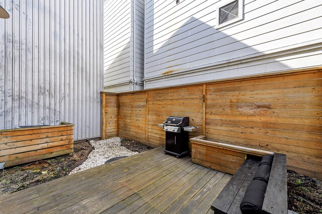 wooden terrace featuring a grill