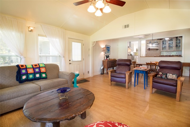 living room featuring vaulted ceiling, hardwood / wood-style floors, and ceiling fan