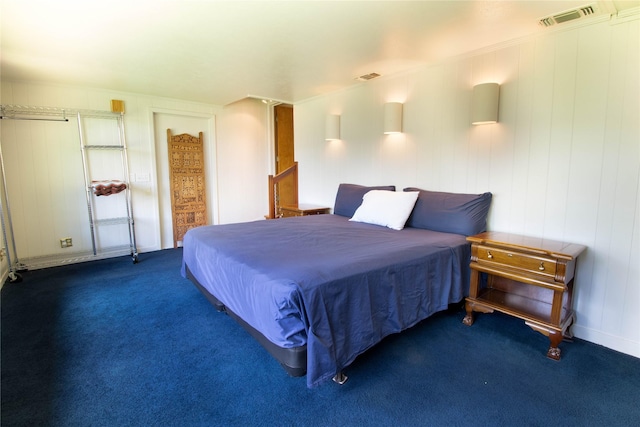 bedroom with dark colored carpet