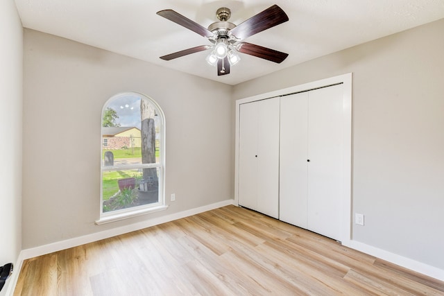 unfurnished bedroom featuring a closet, ceiling fan, and light hardwood / wood-style flooring