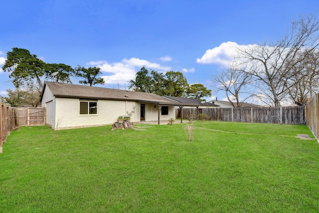 back of property featuring a yard